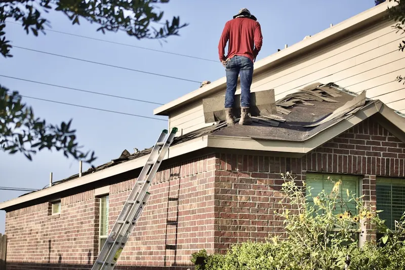 Professional roofer working on a residential roof in Shark River Hills